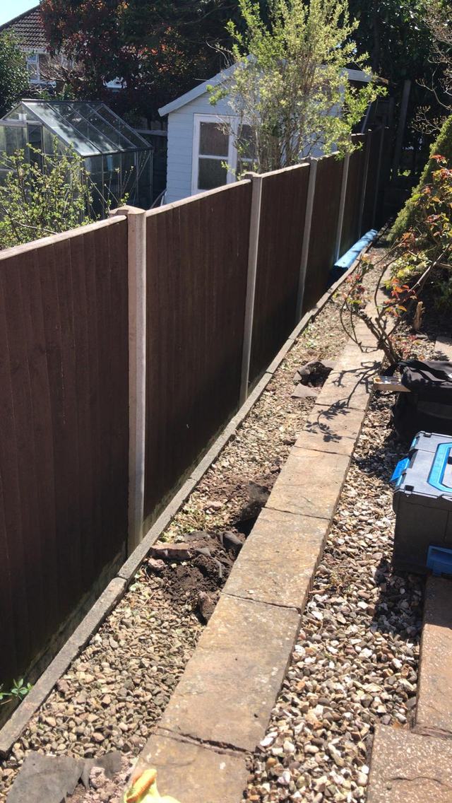 Dark brown fence with a trellis-topped panel in Stourbridge